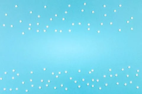 Winter pattern made of small white snowflakes Creative Top view flat lay w... Stock Photos