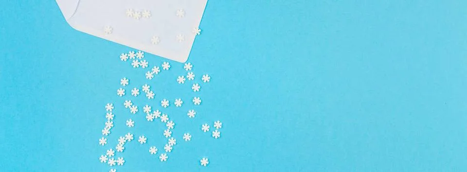 Winter pattern made of small white snowflakes Creative Top view flat lay w... Stock Photos