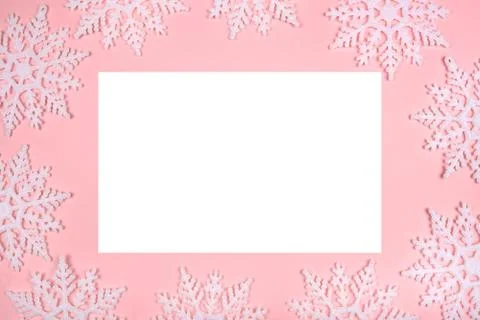 Winter pattern made of snowflakes and on pink background. Stock Photos
