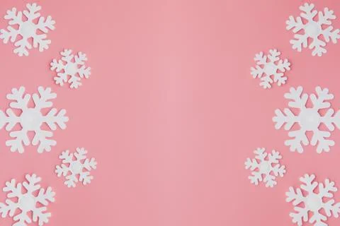 Winter pattern made of snowflakes and on pink background. Christmas concept.  Stock Photos