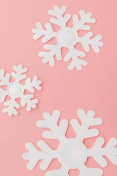 Winter pattern made of snowflakes and on pink background. Christmas concept.  Stock Photos