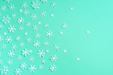Winter pattern made of white snowflakes on trendy green background. Top view Stock Photos