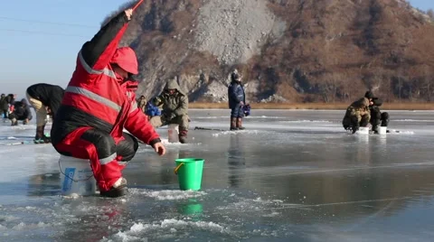 In winter, people catch fish from under the ice in the river. Russia. Stock Footage 58412699