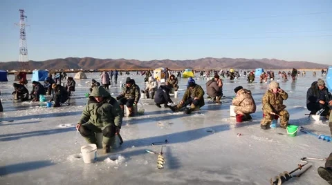 In winter, people catch fish from under the ice in the river. Russia. Stock Footage 58412866