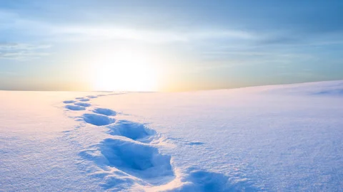 Winter plain covered by a snow at the sunset with human track Stock Footage 245257792