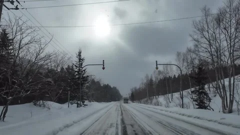 Winter POV Drive With Sun Rays and Oncoming Truck in Furano Japan Stock Footage 333697004