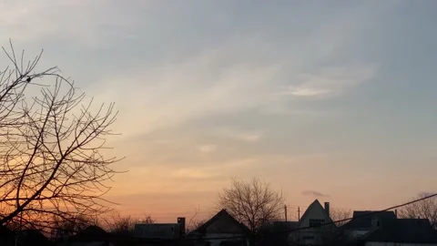 Winter purple sky at sunset with light cirrus clouds in the village Stock Footage 229480915