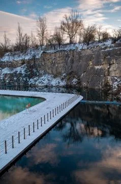 Winter Quarry Pool with Snow-Covered Surroundings Stock Photos