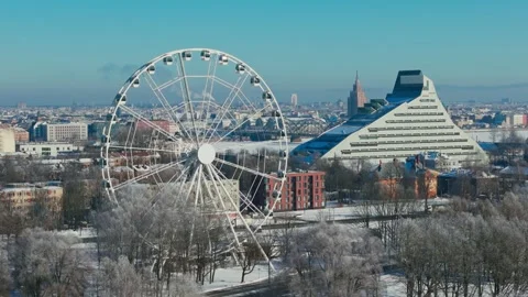 Winter Riga Latvia - Ferris Wheel and National Library in Snowy Cityscape Views Stock Footage 345474401
