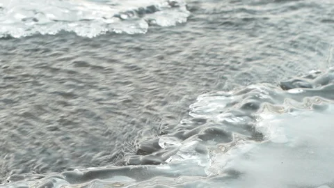 Winter river flows through melting ice Stock Footage 124495294