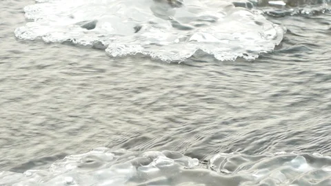 Winter river flows through melting ice Stock Footage 124495468