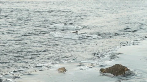 Winter river flows through melting ice Stock Footage 124495535