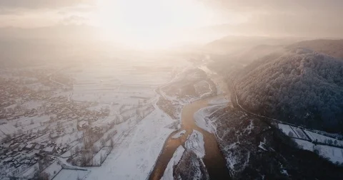 Winter river flying drone snowflakes whirls snowfall sunset Stock Footage 122601550