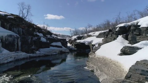 Winter river scene with snow, ice and water flowing. Drone flying over Stock Footage 78736921