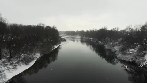Winter river in a snowy daylight between two banks Stock Footage 120301311