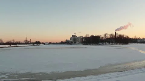Winter river at sunset, with smoking chimney ProRes Stock Footage 10719862