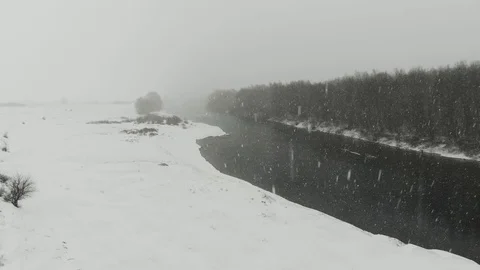 Winter river surrounded by trees and banks of snow-covered Stock Footage 120304103