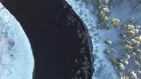 Winter river from top with ice flowing in sunny day in 4K Stock Footage 297998760