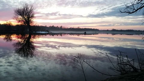 Winter river water sunset w ice and tree on the right 스톡 동영상 73669873