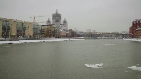 Winter Riverfront Cityscape With Cathedral Under Renovation, Bridge And Modern Stock Footage 330468418