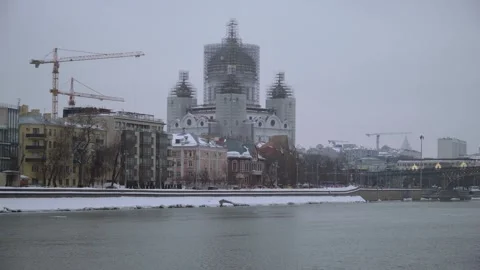 Winter Riverfront Cityscape With Cathedral Under Renovation Stock Footage 347943472