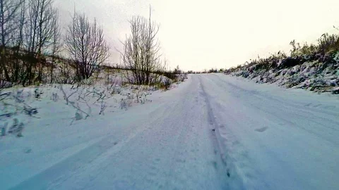 Winter road with an action camera mounted on the front bumper of an off-road car Stock Footage 122606928