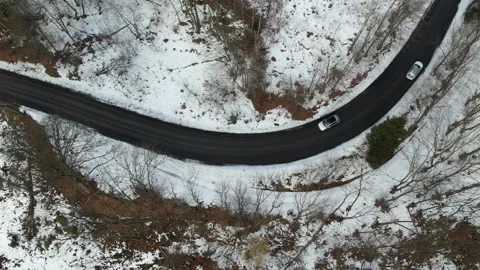 Winter road car Hyundai ionic 5 follow aerial top down view Stock Footage 262389006