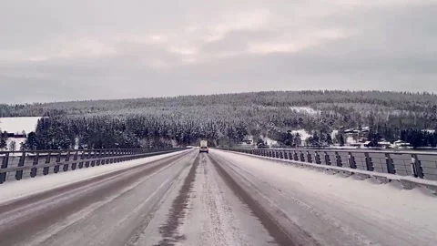 Winter Road Driving over Bridge first person driver snow ice traffic Video stock 145945255