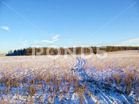 Winter road in the early sunny morning in the suburbs. Stock Photos