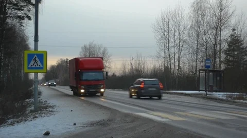 Winter road by the forest at sunset, pedestrian crossing Stock Footage 123595503