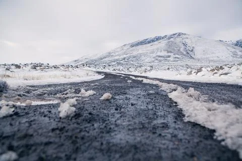 In winter the road to the mountain under clouds and snow Stock Photos