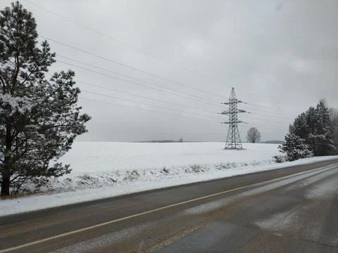 Winter road next to field Stock Photos