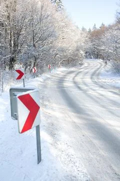 Winter road with red direction arrows Stock Photos