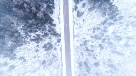 Winter Road in Snow Covered Forest, Aerial Vertical View Stock Footage 85632933