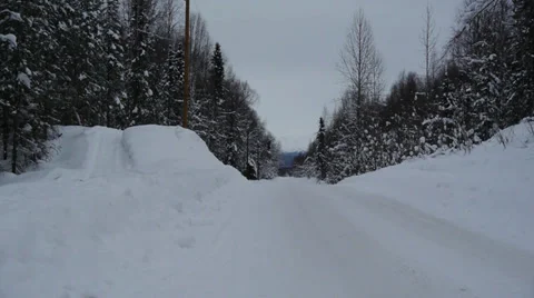 Winter Road, Surrounded by Trees, Cleared Snow Piled on Sides Stock Footage 38080887