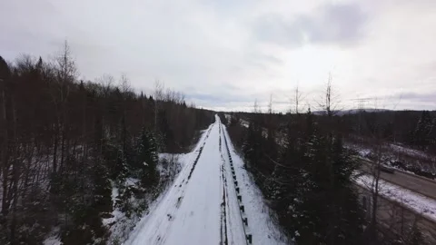 Winter Road Through Forest – Aerial FPV Flyover Stock Footage 321657655