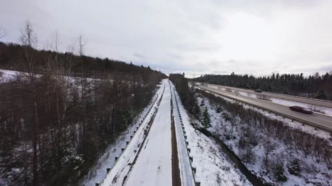 Winter Road Through Forest – Aerial FPV Flyover Stock Footage 321657698