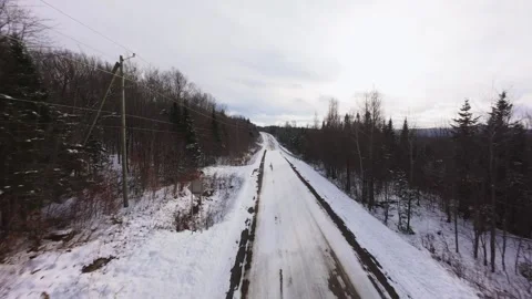 Winter Road Through Forest – Aerial FPV Flyover Stock Footage 321657785