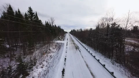 Winter Road Through Forest – Aerial FPV Flyover Stock Footage 321657896