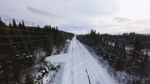 Winter Road Through Forest – Aerial FPV Flyover Stock Footage 321657914
