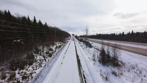 Winter Road Through Forest – Aerial FPV Flyover Stock Footage 321657976