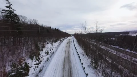 Winter Road Through Forest – Aerial FPV Flyover Stock Footage 321658020