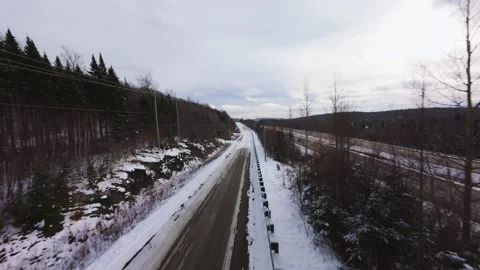 Winter Road Through Forest – Aerial FPV Flyover Stock Footage 321658078
