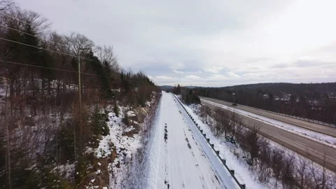 Winter Road Through Forest – Aerial FPV Flyover Stock Footage 321658118