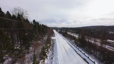 Winter Road Through Forest – Aerial FPV Flyover Stock Footage 321658125