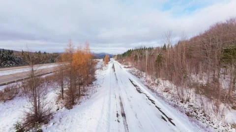 Winter Road Through Forest – Aerial FPV Flyover Stock Footage 321659402