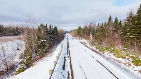 Winter Road Through Forest – Aerial FPV Flyover Stock Footage 321659426