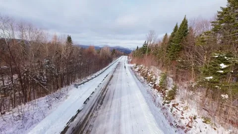 Winter Road Through Forest – Aerial FPV Flyover Stock Footage 321659457