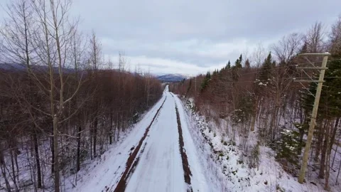 Winter Road Through Forest – Aerial FPV Flyover Stock Footage 321659554
