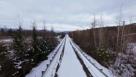 Winter Road Through Forest – Aerial FPV Flyover Stock Footage 321659583
